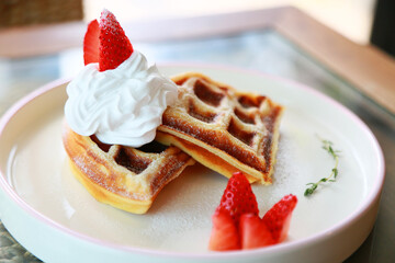 Waffle get served in the morning in the restaurant or the cafe. Food and drink set made by chef and served with hot drink. Healthy food or junk food was select by people.