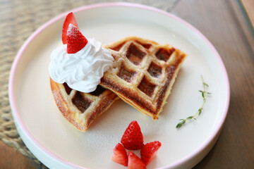 Waffle get served in the morning in the restaurant or the cafe. Food and drink set made by chef and served with hot drink. Healthy food or junk food was select by people.