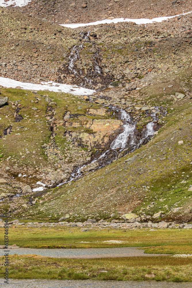 Canvas Prints Waterfall on a mountain side that flows into a lake