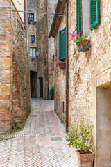 Fototapeta na wymiar Narrow old alley to a backyard in an Italian village