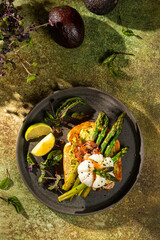 Grilled Toast witch Asparagus, avocado, Poached egg, greens, bacon on green textured background. banner, menu recipe place for text, top view. Traditional breakfast.