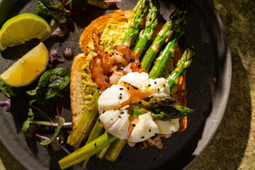 Grilled Toast witch Asparagus, avocado, Poached egg, greens, bacon on green textured background. banner, menu recipe place for text, top view. Traditional breakfast.