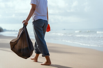 Volunteer man and plastic bottle, clean up day, collecting waste on sea beach, pollution and...