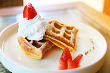 Waffle get served in the morning in the restaurant or the cafe. Food and drink set made by chef and served with hot drink. Healthy food or junk food was select by people with warm light.