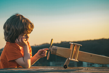 Kids dreams of traveling. Cute kids face. Summer at countryside. Kid dreams of future. Kid pilot dreaming. Childhood dream concept. Blonde cute daydreamer child dream on fly. Dreams and imagination.