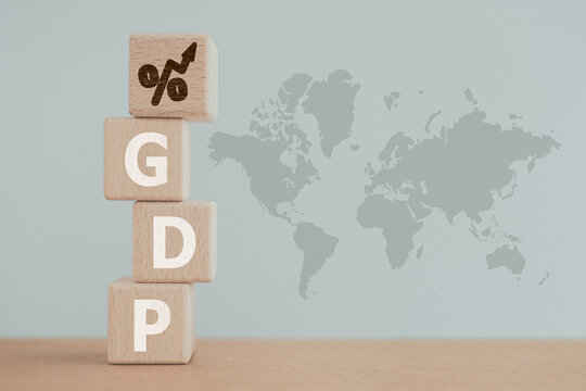 For  global economy GDP text, gross domestic product , on stack of wooden cube block with increasing percent on top and world map background