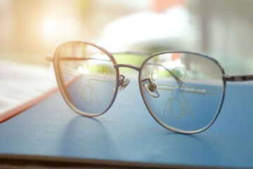 glasses on a book, Eyeglasses on table, progressive lenses, eyeglasses for the elderly, glasses...