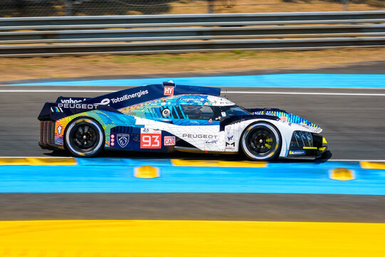 Le Mans, France - June 10, 2023: The Peugeot 9X8 race car No. 93, from the Peugeot TotalEnergies team, in the Tertre Rouge turn on the Circuit de la Sarthe race track during the 24 hours of Le Mans.