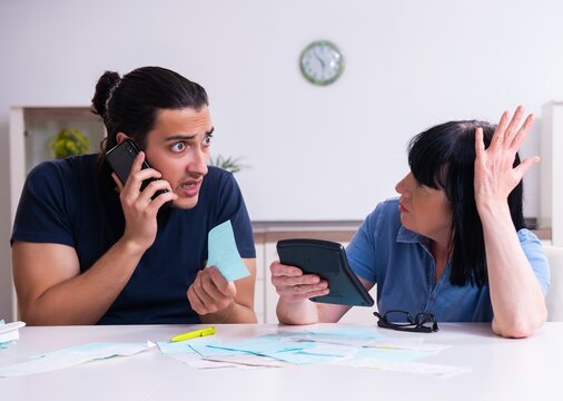 Female pensioner and her young son in budget planning concept