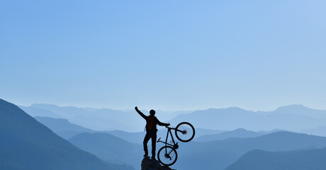 The Happiness of the Mountain Cyclist Young Man Climbing to the Top