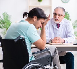 Male patient in wheel-chair visiting old doctor