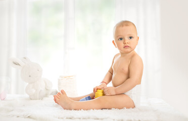 Baby in diaper with rubber toy