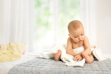 Baby playing with diapers