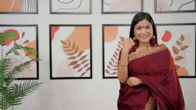 Indian woman pointing left for product placement
