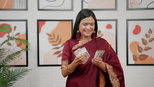 Indian mother counting money with happiness