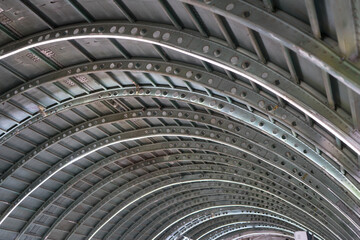 Arched roof steel structure the design for framework look like tunnel. building roof carcass .Old  architectural iron construction.