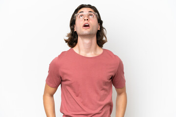 Fototapeta premium Young handsome man isolated on white background looking up and with surprised expression