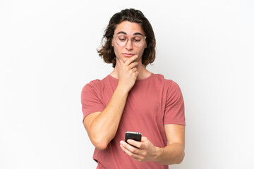 Young handsome man isolated on white background thinking and sending a message