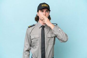 Young safeguard man isolated on blue background having doubts and with confuse face expression