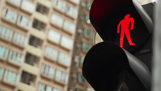 Traffic Signal Transition: Close-Up Shot of Red to Green Pedestrian Light in Hong Kong