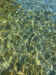 Naklejka na ściany i meble Sea clear water pebbles stones gravel at the bottom of ocean.