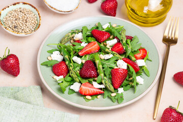 Salad with strawberries, asparagus, arugula, white cheese and nuts. Healthy eating. Vegetarian food.