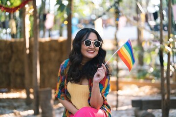  Happy Asian woman support LGBT pride parade.with Rainbow of LGBTQ or LGBTQIA .