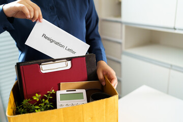 Quit Job Business man sending resignation letter and packing Stuff Resign Depress or carrying business cardboard box in office. Change of job or fired from company.