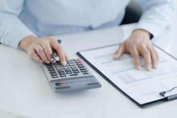 Businesswoman Accountant analyzing investment charts Invoice and pressing calculator buttons over documents. Accounting Bookkeeper Clerk Bank Advisor And Auditor