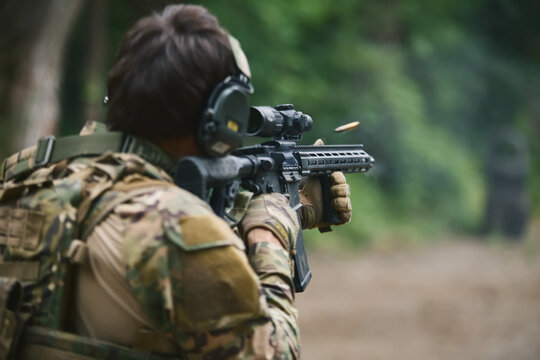 Ukrainian soldier shooting on sight with a modern American assault rifle equipped with optical scope. Armed forces of Ukraine training for the counter offensive operation
