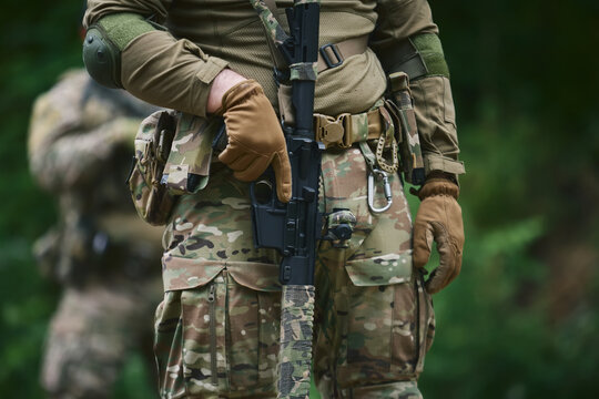 Young soldiers training on the shooting. Group of Ukrainian marines preparing for the battle. Recruit armed with modern American assault rifle and equipped with modern green camouflage