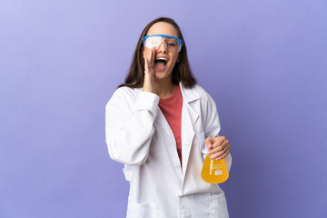 Young scientific woman over isolated background shouting with mouth wide open
