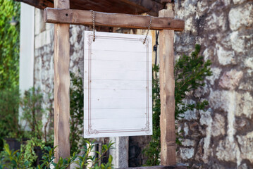 Old fortress signage restaurant logo mockup. White wooden surface with copy space