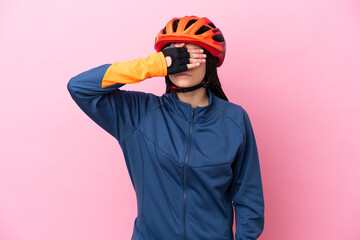 Teenager cyclist girl isolated on pink background covering eyes by hands. Do not want to see something