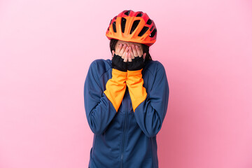 Teenager cyclist girl isolated on pink background with tired and sick expression - obrazy, fototapety, plakaty