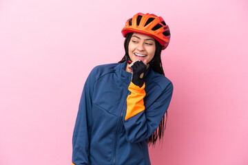 Teenager cyclist girl isolated on pink background looking to the side and smiling - obrazy, fototapety, plakaty