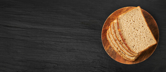 Brown Bread Slices on Black Plate Background