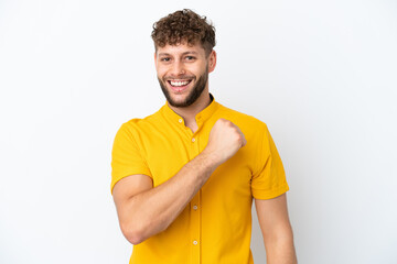 Young handsome caucasian man isolated on white background celebrating a victory