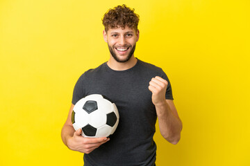Handsome young football player man isolated on yellow background celebrating a victory in winner position - Powered by Adobe