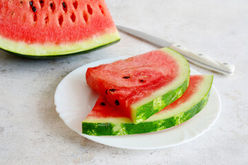 two watermelon slices on white plate isolated, copy space 