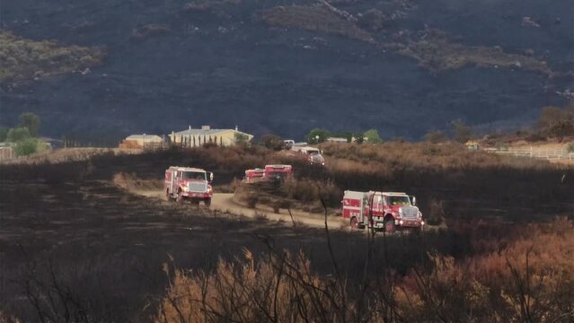 Emergency Vehicle Driving on a Dirt Road With Burnt Bushes on the Side of the Road Fairview Fire California