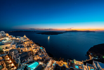 Blue hour in Fira overlooking the caldera on Greek island of Santorini - obrazy, fototapety, plakaty