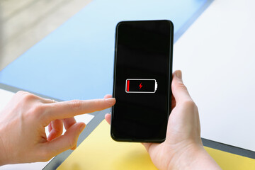 Close-up of a smartphone in female hands. Woman at the table of a street cafe surf the internet. Using smartphone, wasting time on social media, online shopping.