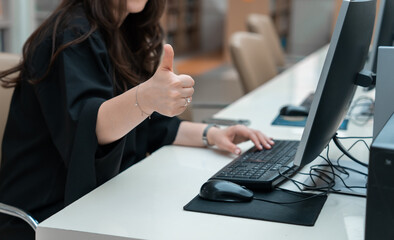 Sitting in front of the computer shows a thumbs up