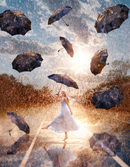 Beautiful woman with flying umbrellas in summer rain