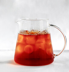  teapot of cold iced tea on white