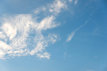 Scattered cloud clusters in a blue sky, blue sky background with white clouds.