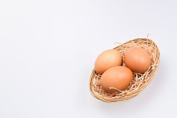 Three Brown Eggs in Rattan Basket Slant II