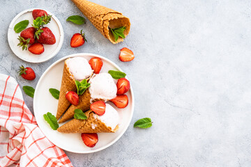 Homemade ice cream with fresh strawberries on stone table. Flat lay.