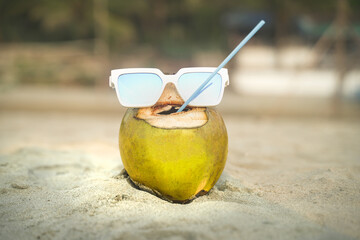 Cheerful coconut imitating a human wearing sunglasses